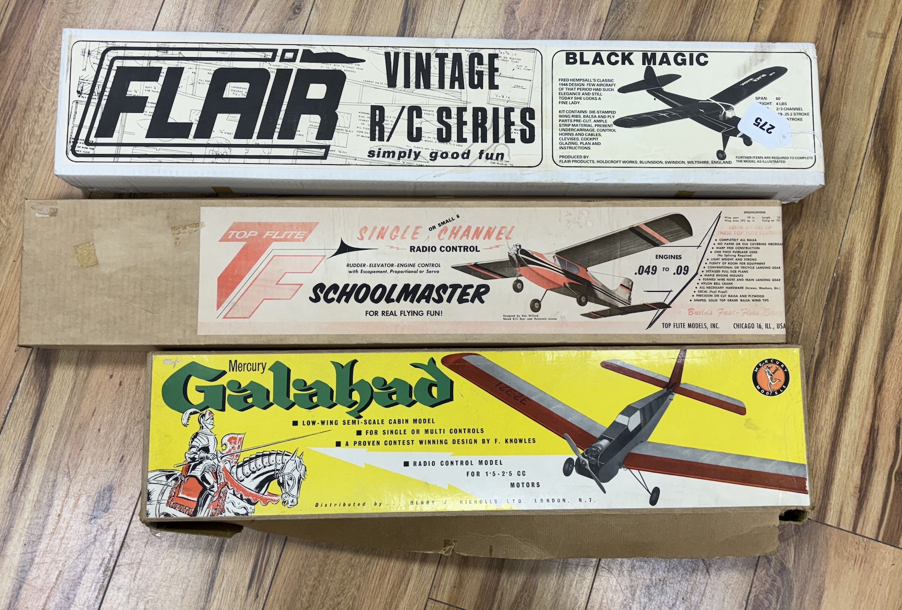 Three large wooden aircraft kits; a Flair Black Magic, a Top Flight Schoolmaster and a Mercury Galahad, longest box 79cm